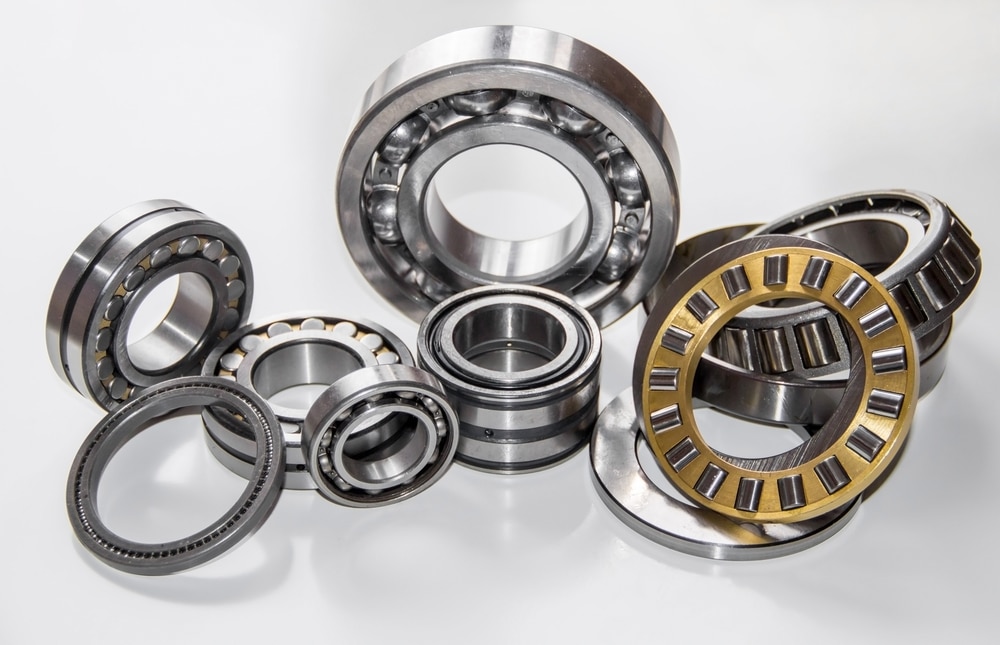 An assortment of various ball bearings and roller bearings of different sizes